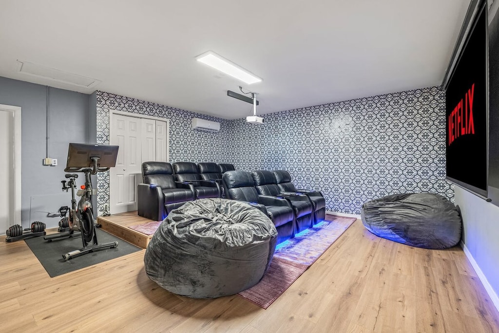 In-home movie theater- sit back relax in the luxury reclining seats or a bean bag- This room also features a Peloton, adjustable weights, and yoga mat!