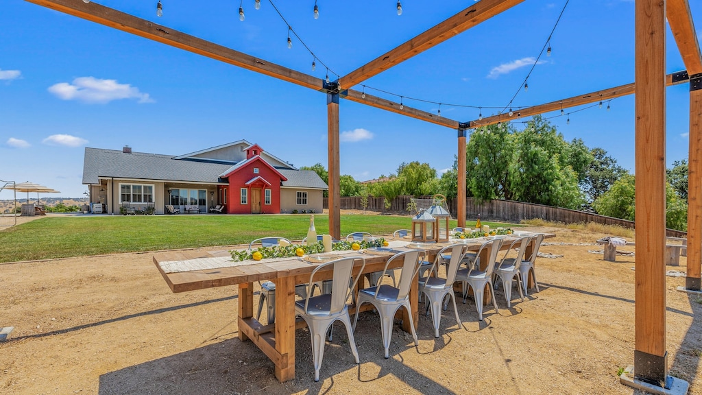 Large, open-air dining table overlooking the private soccer field.