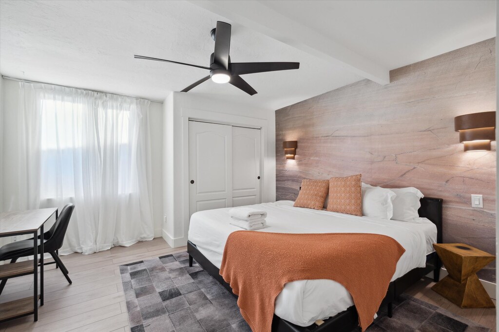 Cozy third room with lush queen bed, adorned with a fandelier.