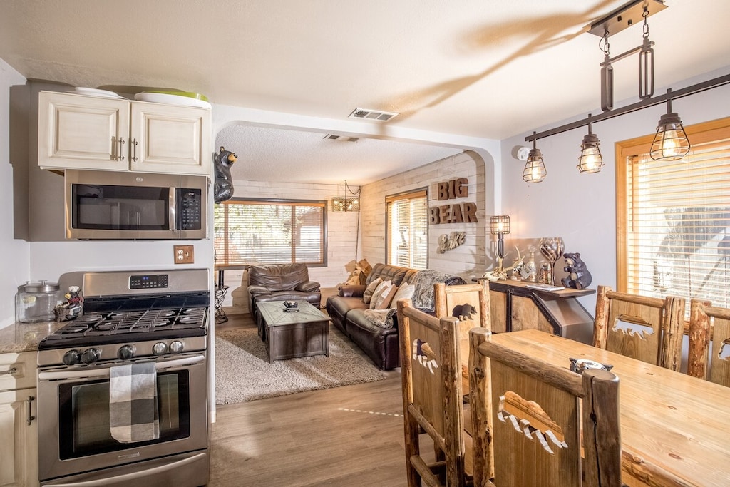 Open stainless steel sparkling kitchen with granite counters.