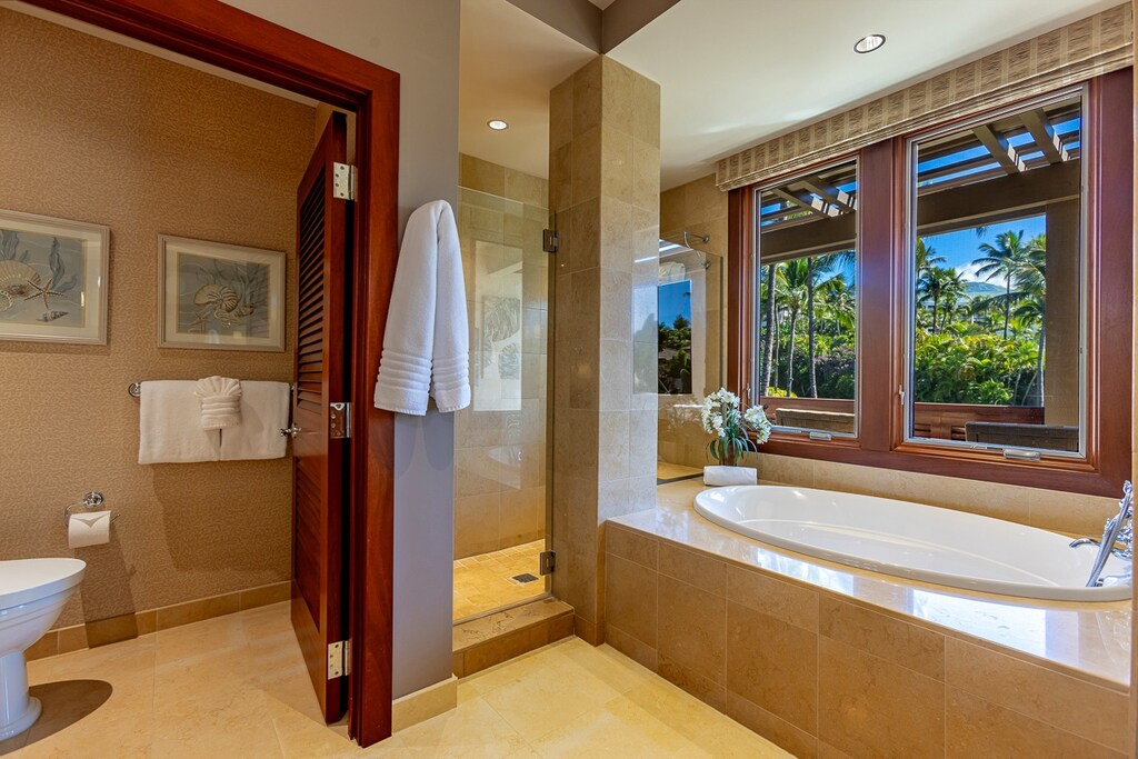 Guest ensuite featuring a walk in shower and large soaking tub