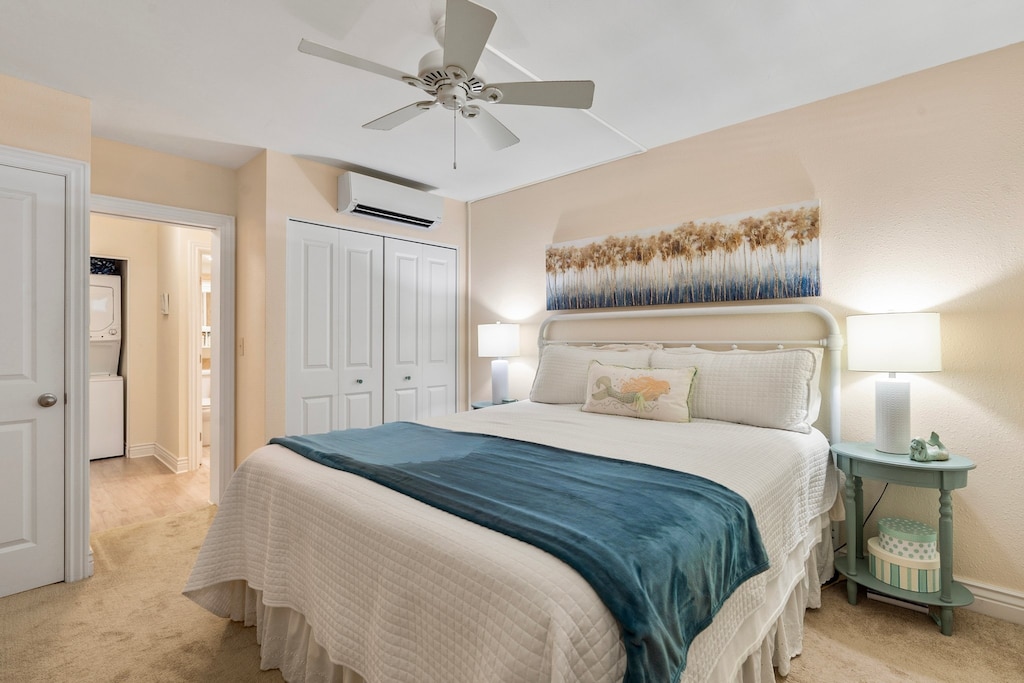 Coastal bedroom with AC~ closet space and ceiling fan.