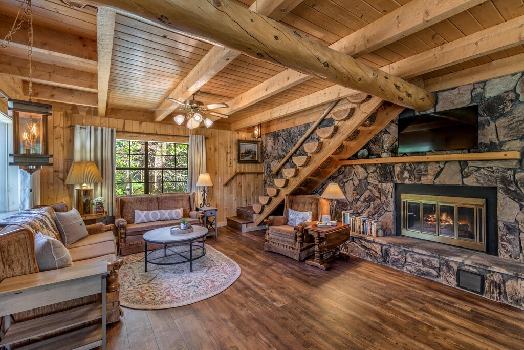 Living room with river view, 1/2 log staircase up to the third floor.