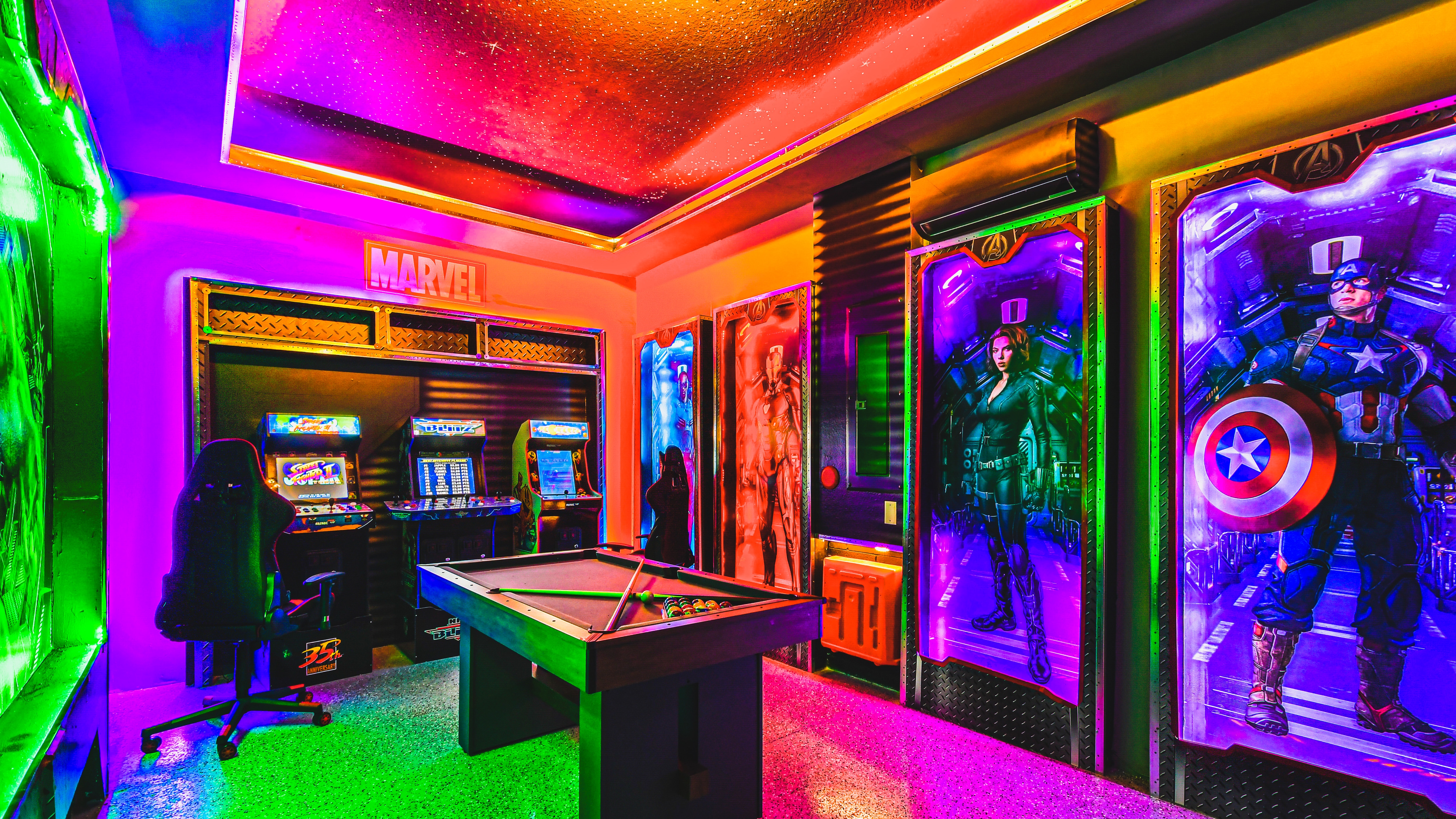 Arcade haven in Marvel decor, featuring games and pool table for epic gaming nights