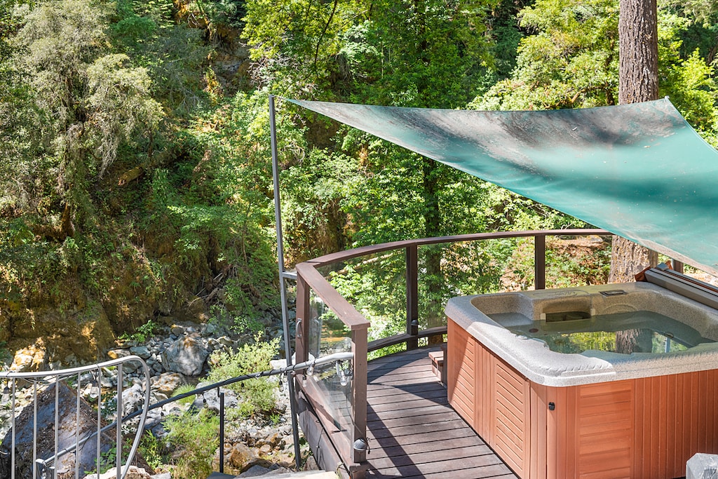 Enjoy the hot tub any time of day - it has a shade cover.