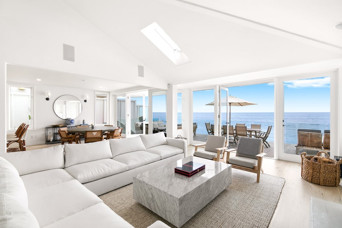 Wall-to-wall, floor-to-ceiling glass brings the ocean and sunset views into the home.