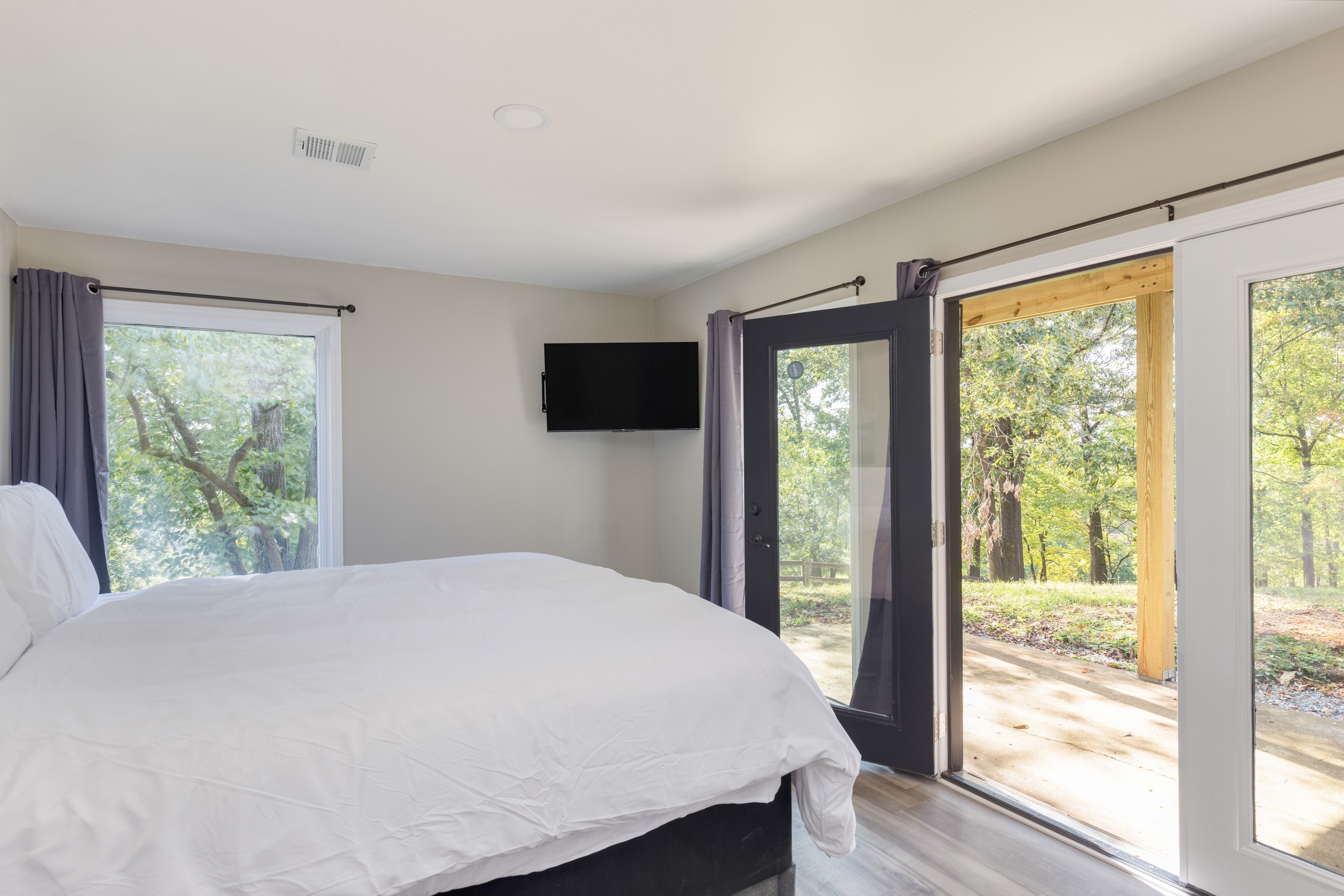 Bedroom 3 features a queen bed, TV, and outdoor access.