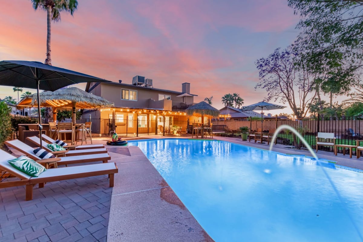 Lareg pool deck with sparkling blue pool and plenty loungers