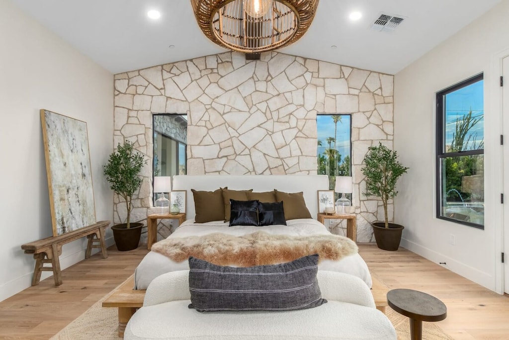 Luxurious Primary Suite with King Bed, natural stone accent wall, Smart TV and Patio Access