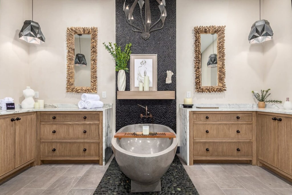Custom Primary En-suite bathroom with his & hers vanities, natural stone soaking tub
