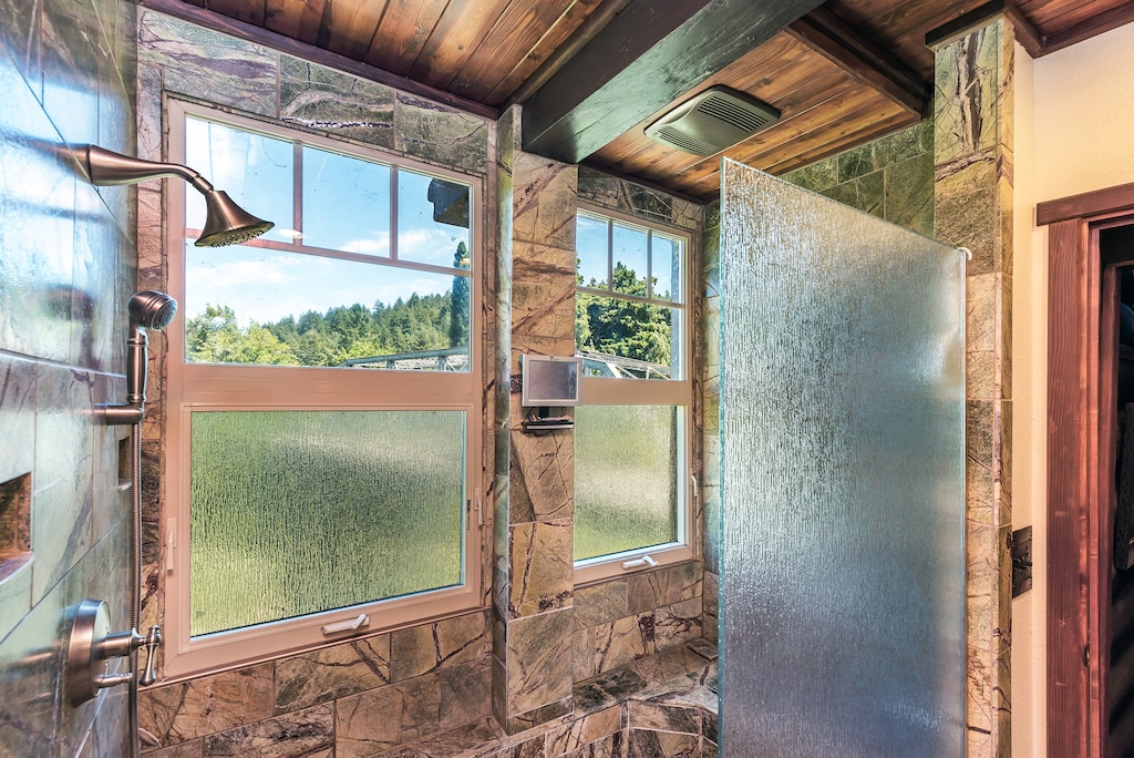 Stone tile, rain-style showerhead, and river views (sort of)!