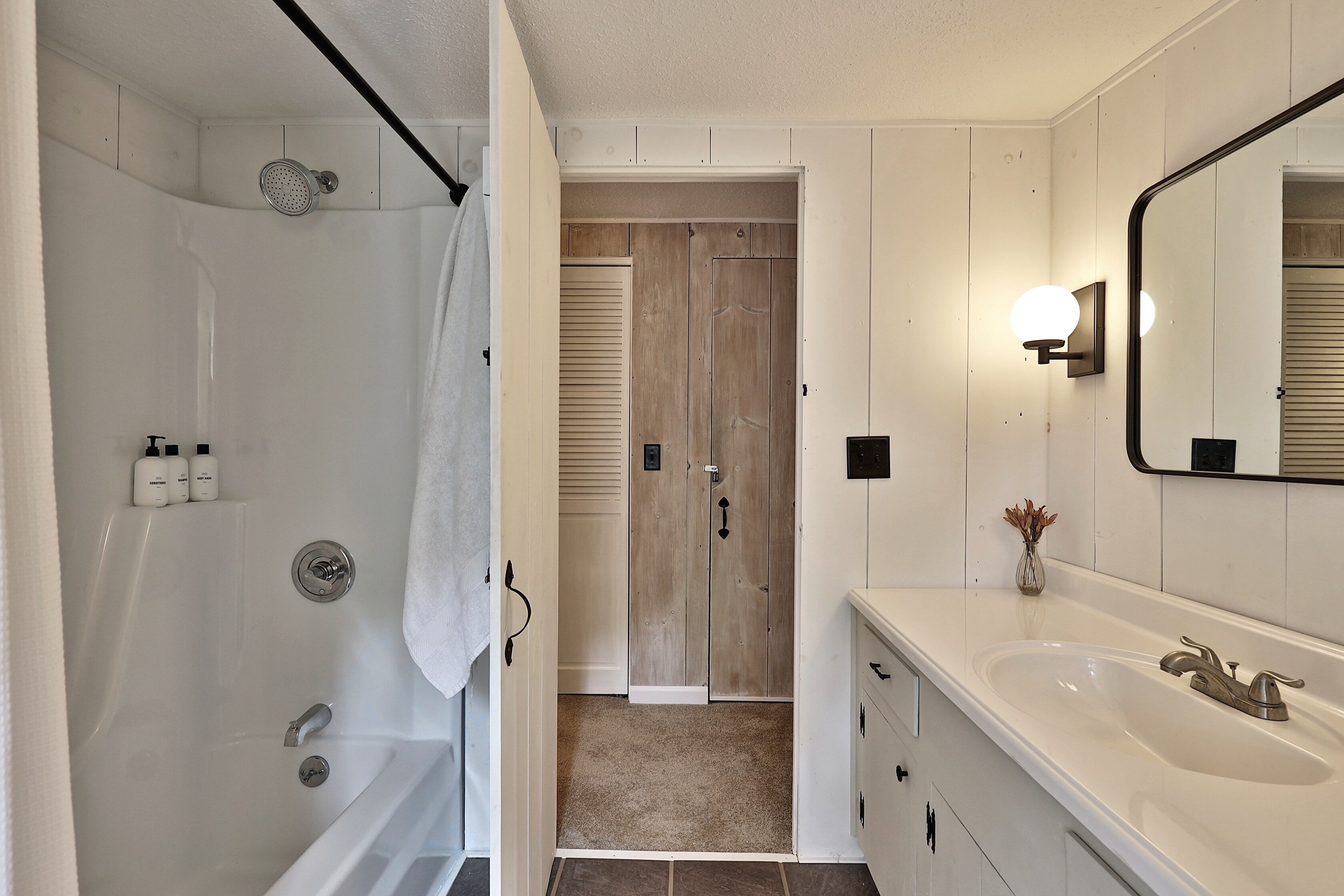 Bright spacious bathroom with tub shower