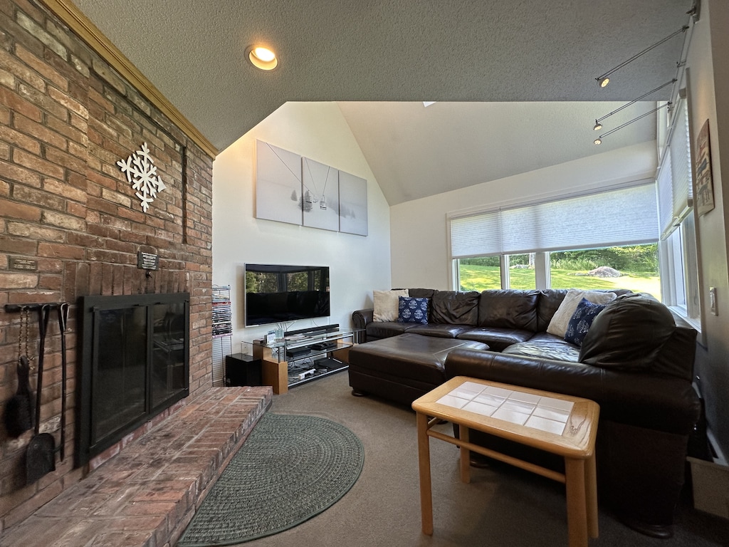 Cozy living room area and wood burning fireplace.