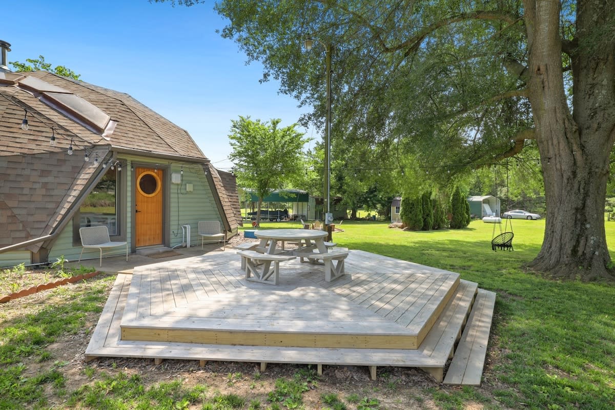 Outside, enjoy an acre of private land, including this custom-built HEXAGON DECK with outdoor seating!