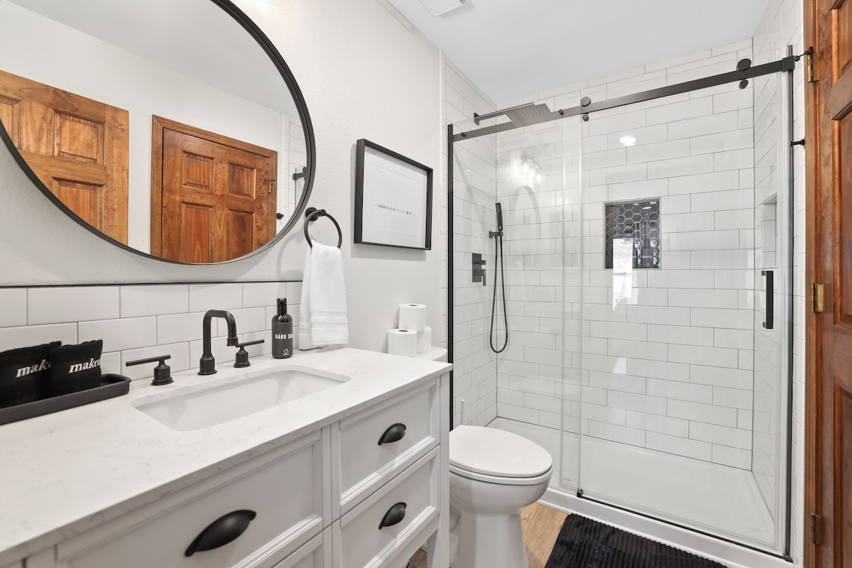 The Master bath has a single sink, lots of counter space and a stunning glass shower with rain shower head.