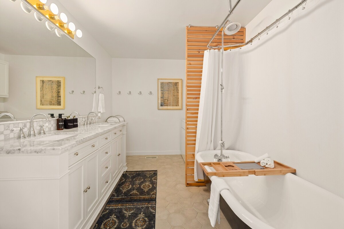 Off the living room, you'll find our hall bathroom complete with a soaking tub and washer / dryer.