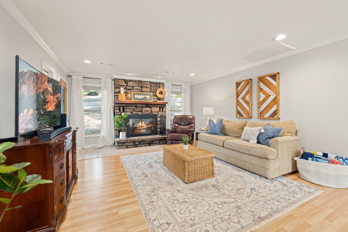 Our spacious living room complete with a large Smart TV, stone fireplace, local wood art, & a Queen sleeper sofa.