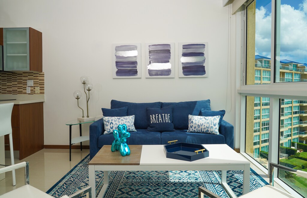 Relax on the plush sofa and take in views of the surrounding property, or unwind with the soothing artwork and modern decor framing your tranquil escape.