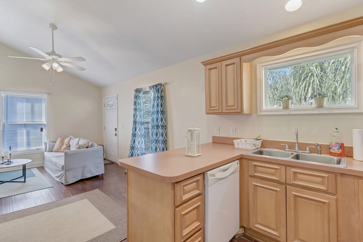 Large kitchen includes dishwasher, double sided sink with disposal, and lots of counter space