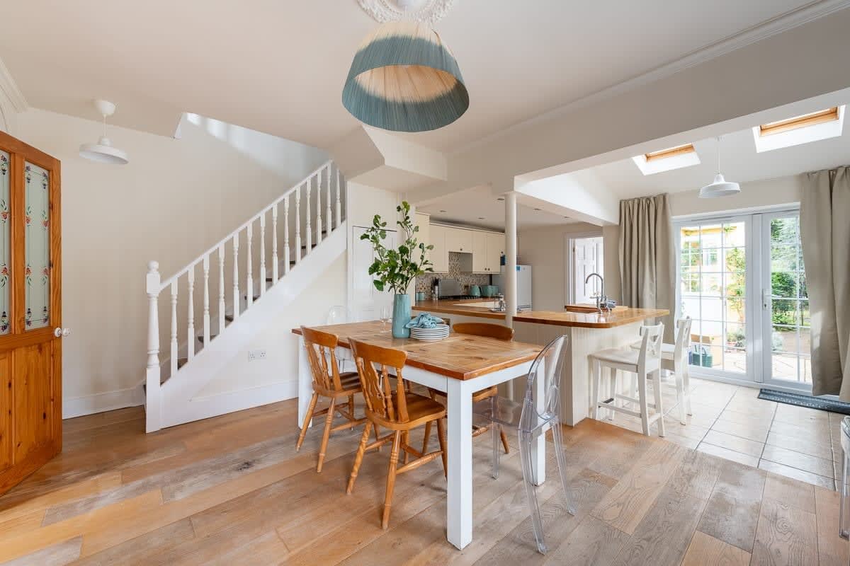 Bright dining room serves as a charming and inviting sanctuary, where loved ones can gather