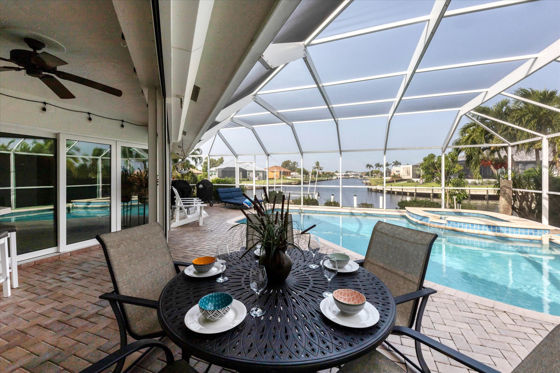 Spacious outdoor area with dining table overlooking the water