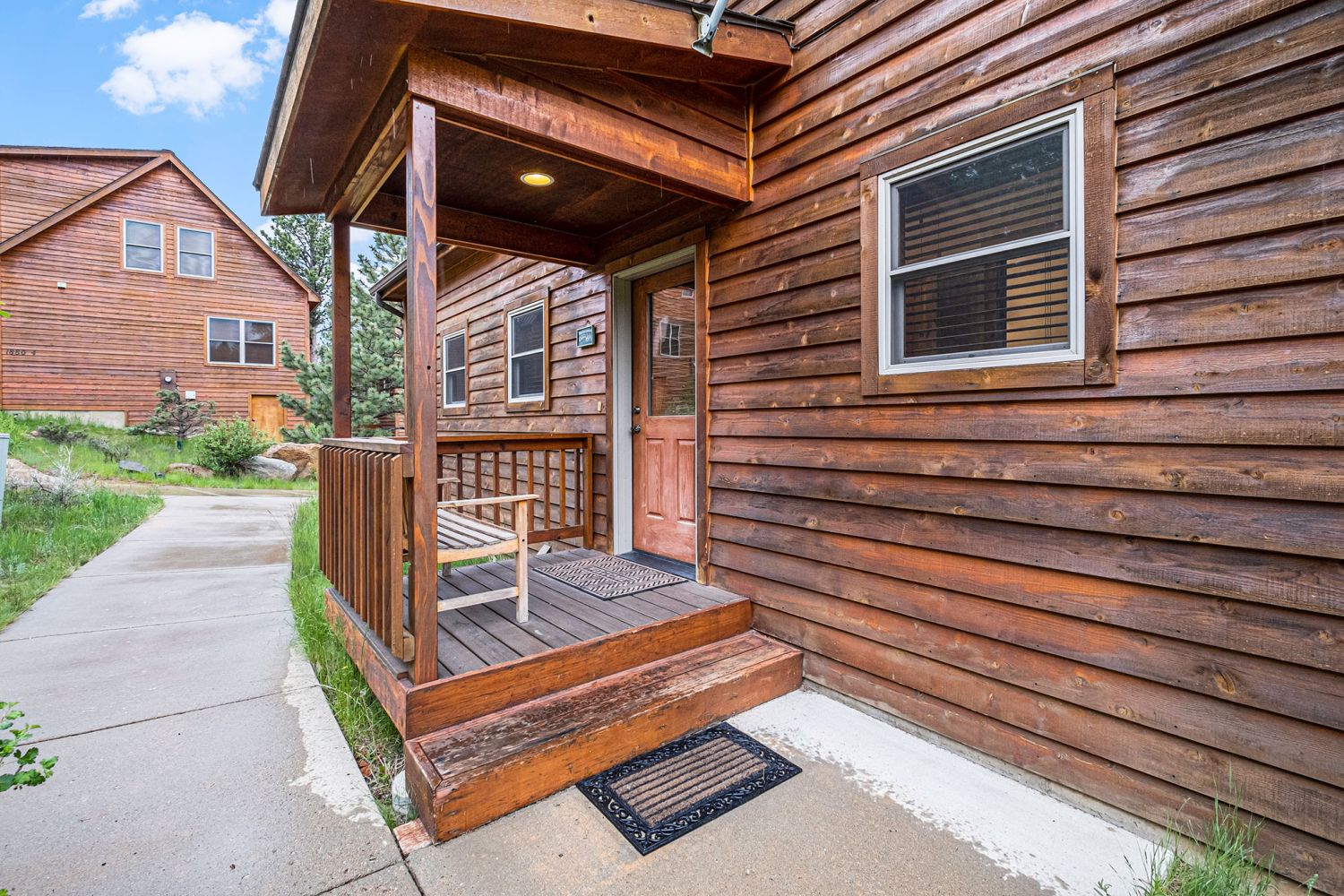 Solitude Bighorn 5 - Exterior front door, with small porch and bench.