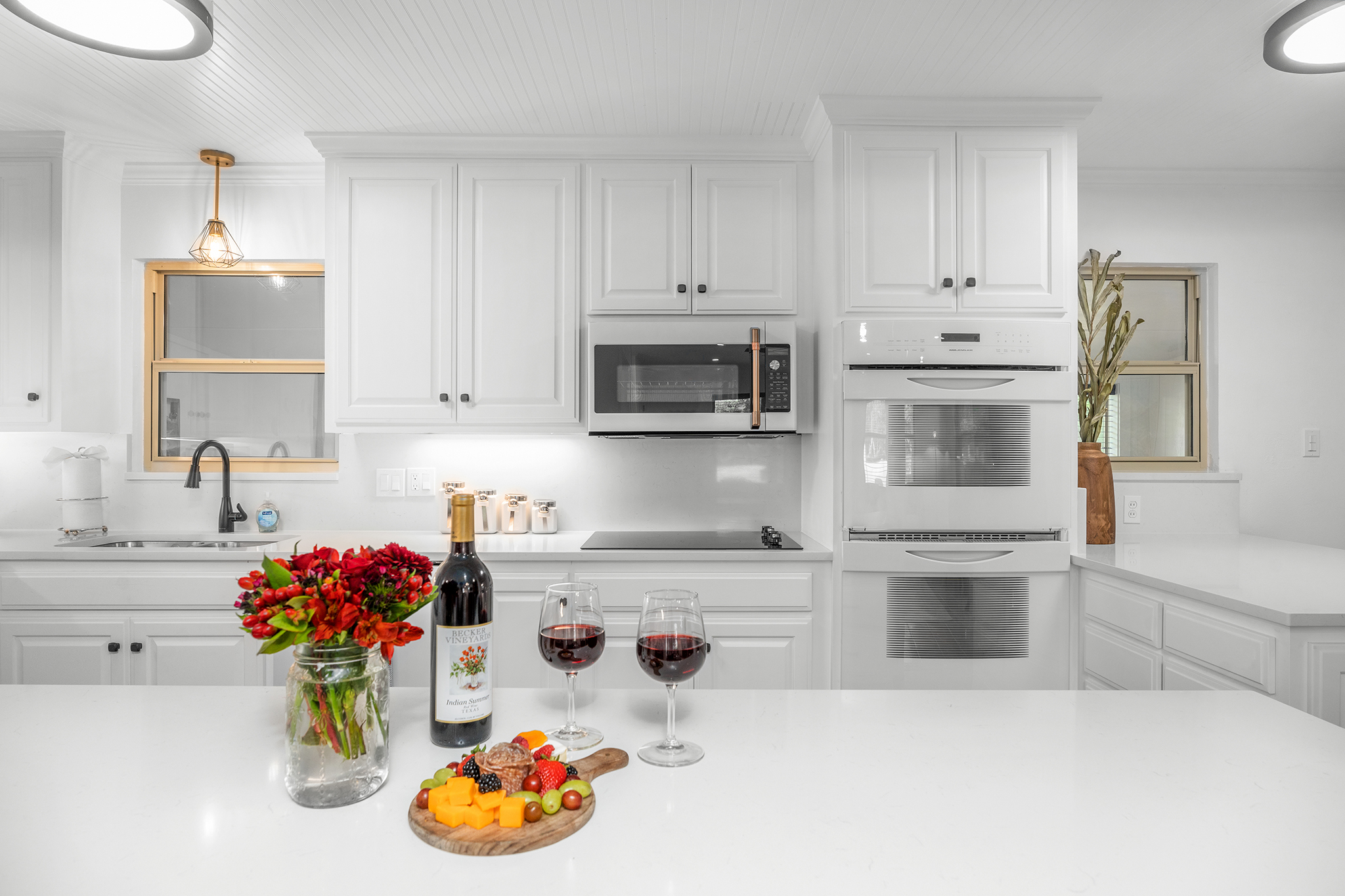 Gather in style and create delicious memories in our inviting white kitchen with a large island - the ideal spot to pair your favorite bottle of wine with delectable local cheeses.