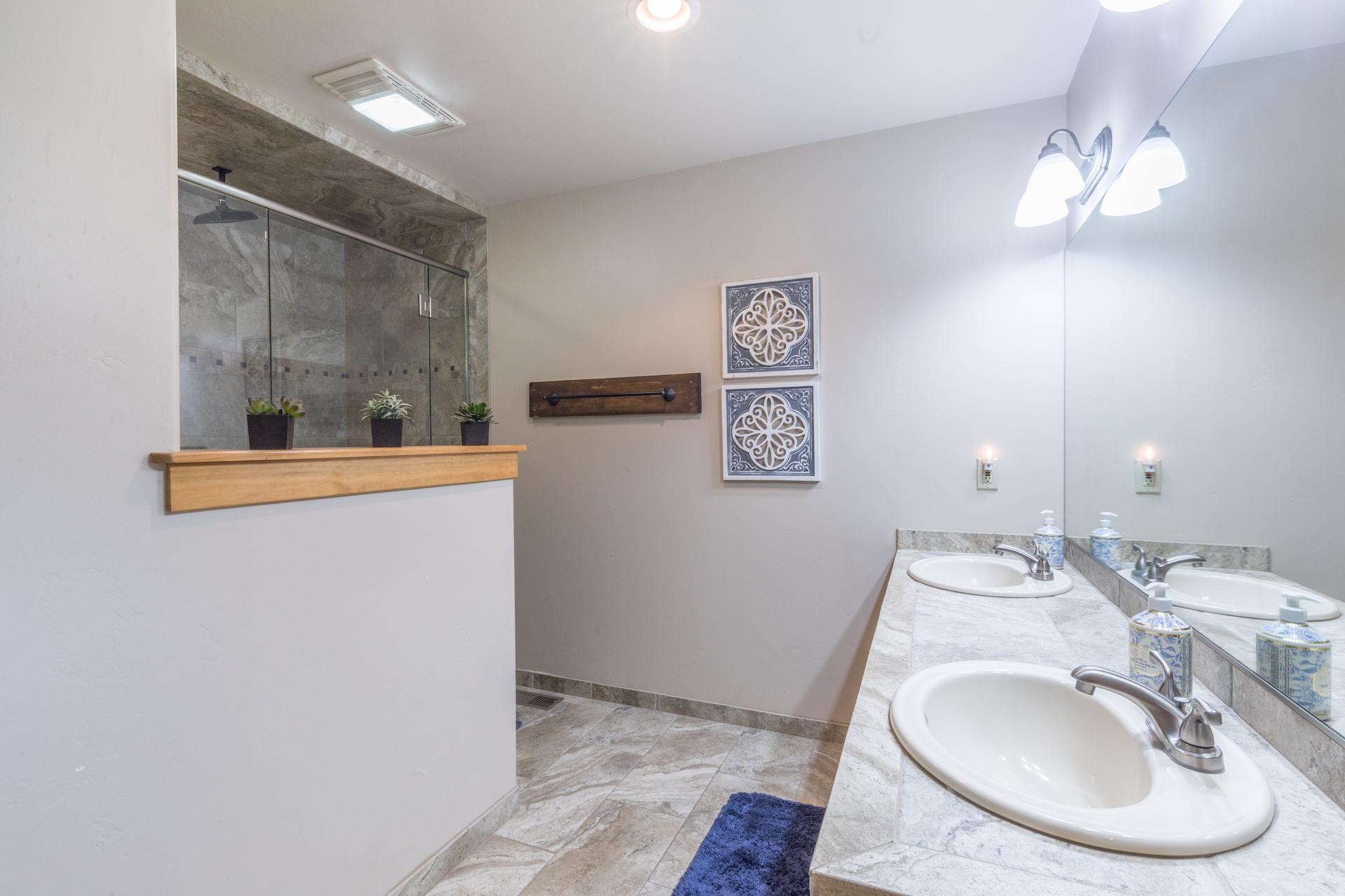 Ensuite bathroom in main bedroom with walk-in shower and double sinks.