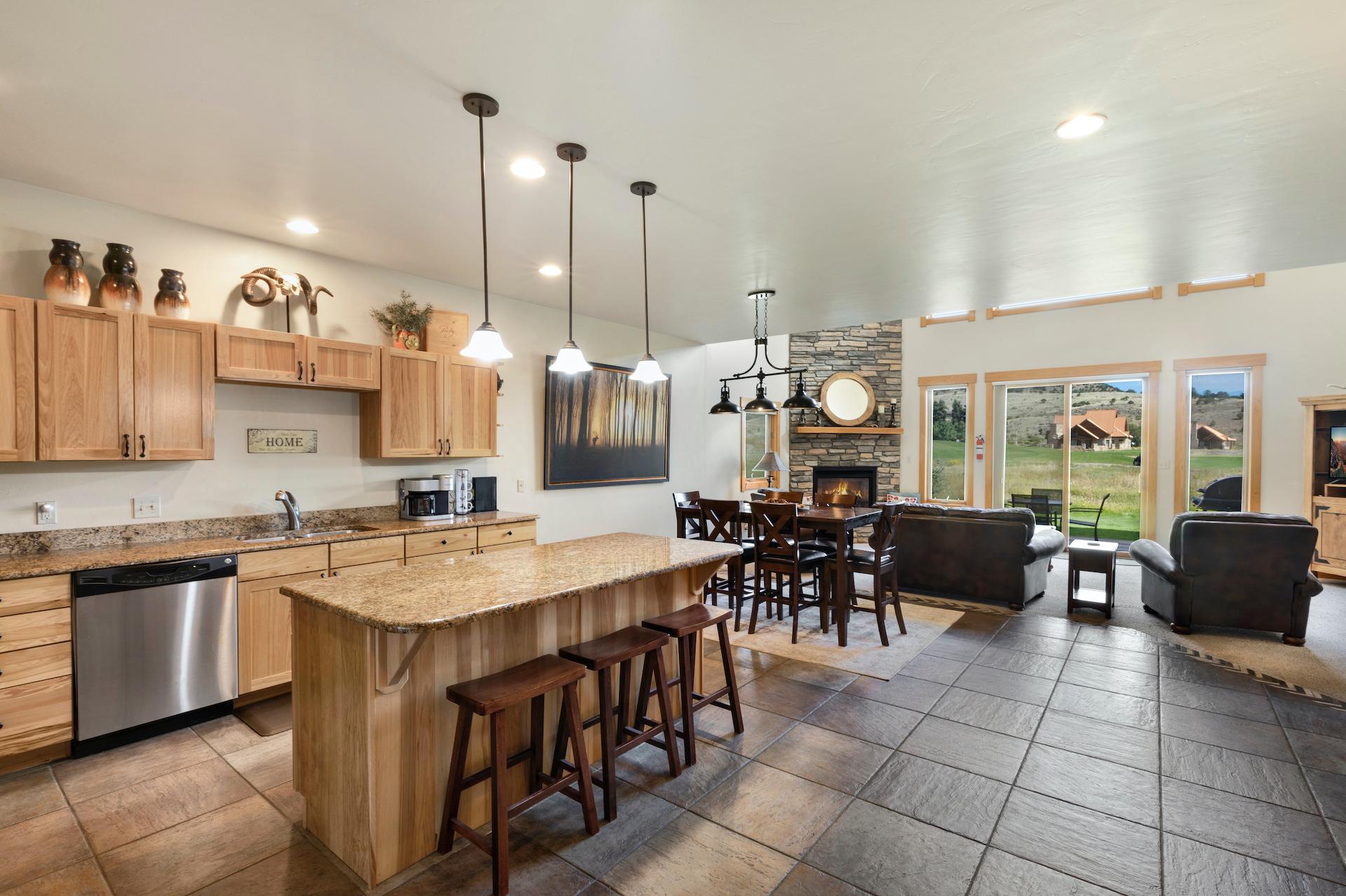 Open kitchen with granite countertops with views of the 9th green.