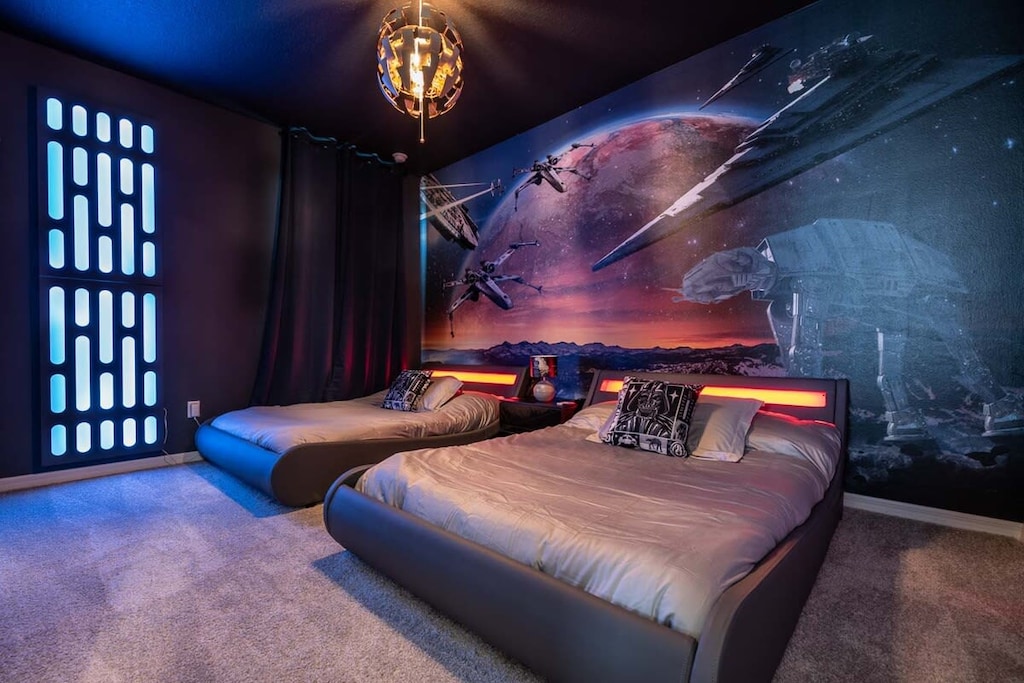 Immerse yourself in a galactic adventure with this space-themed room, featuring illuminated beds and stunning wall art.