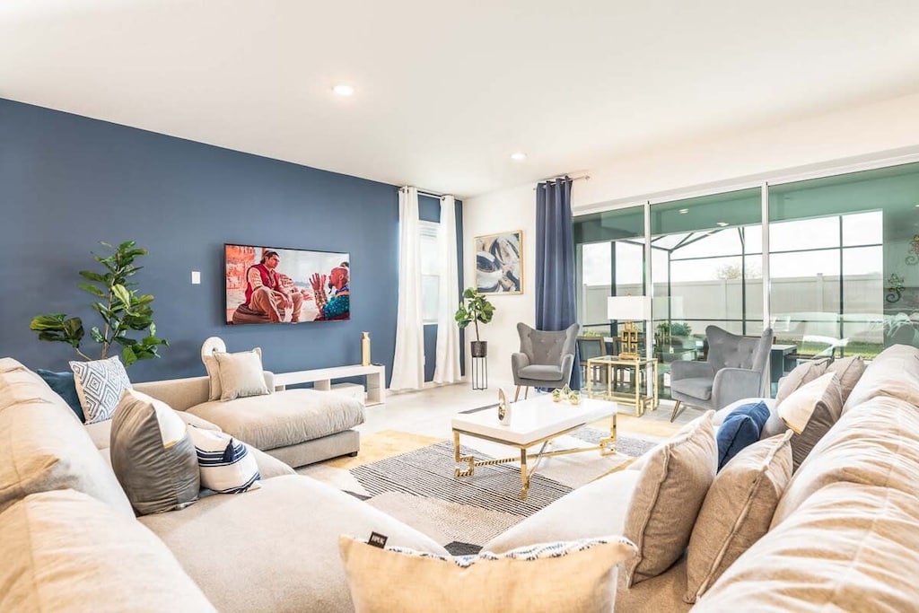Relax in this stylish living room with plush seating and a seamless indoor-outdoor flow to the patio.