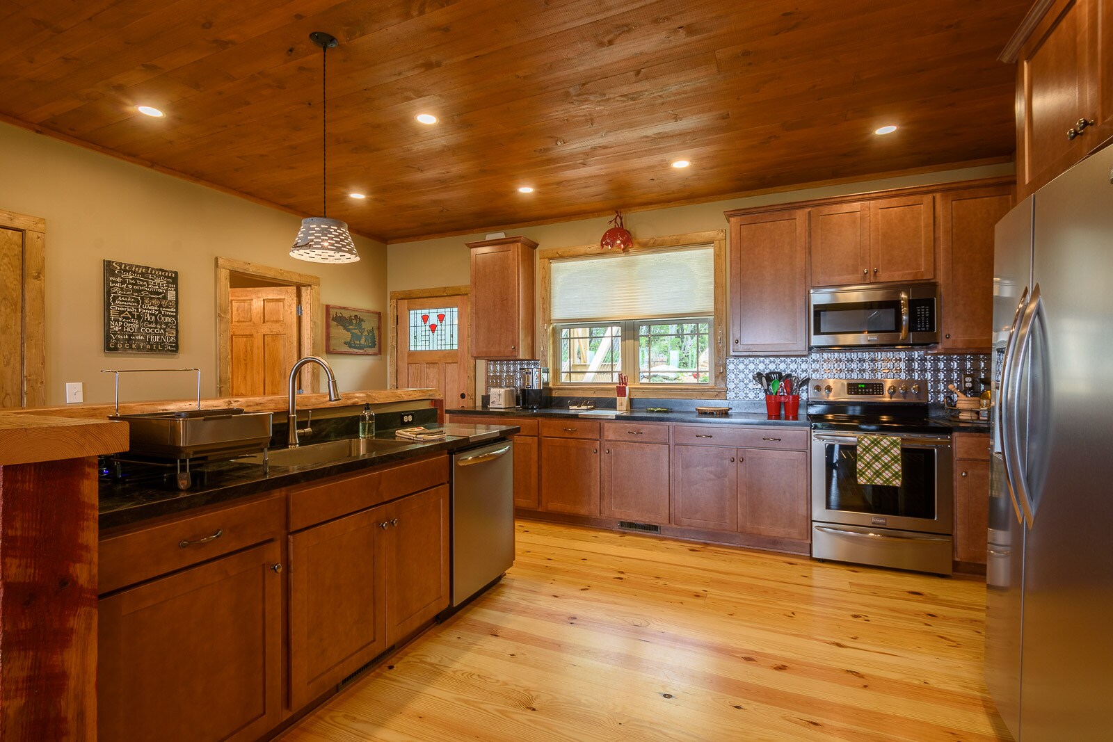 Large kitchen featuring a bar and stainless steel appliances