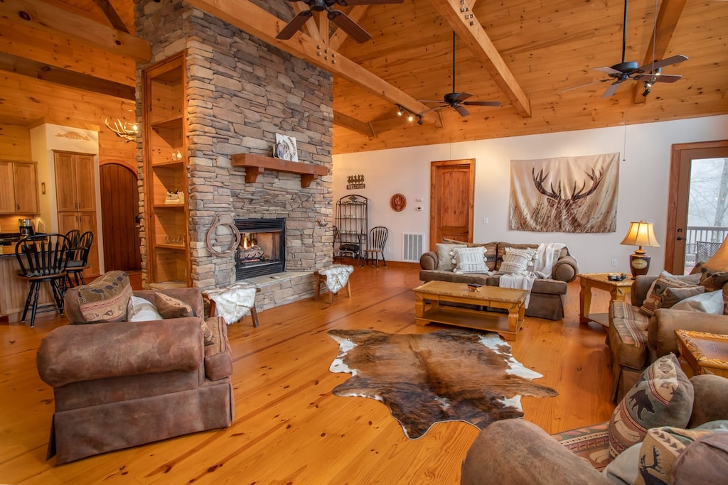 Great Room open to Kitchen and Dining, all of which flank the Central Gas Log Fireplace