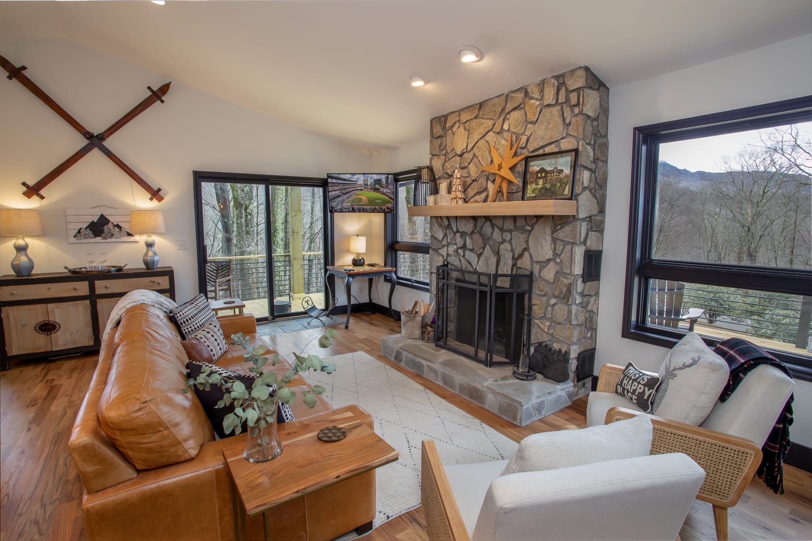 Stone Wood Burning Fireplace flanked by Huge View Windows in Living Room at Lanes End