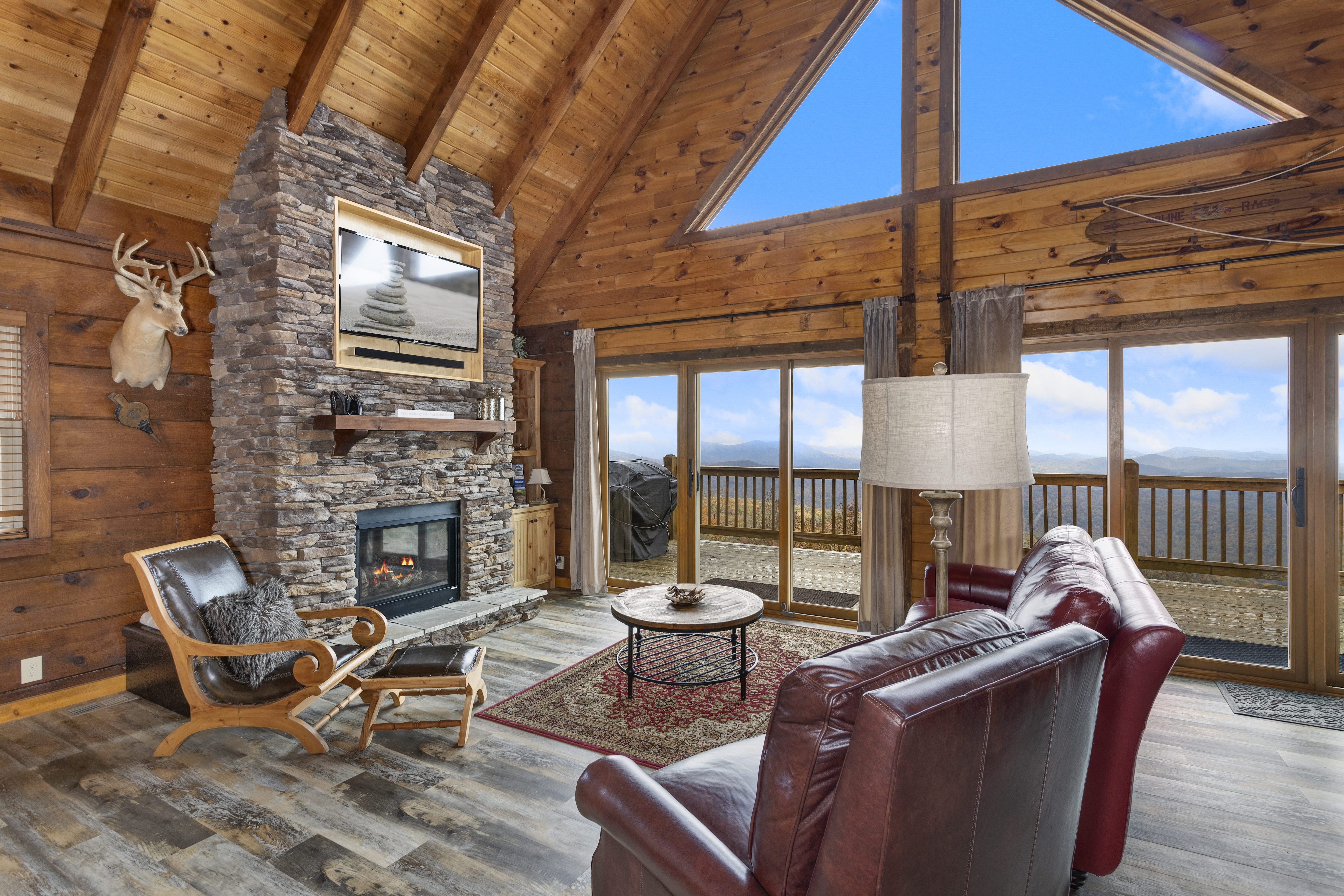 Living Room With Stone Fireplace and TV