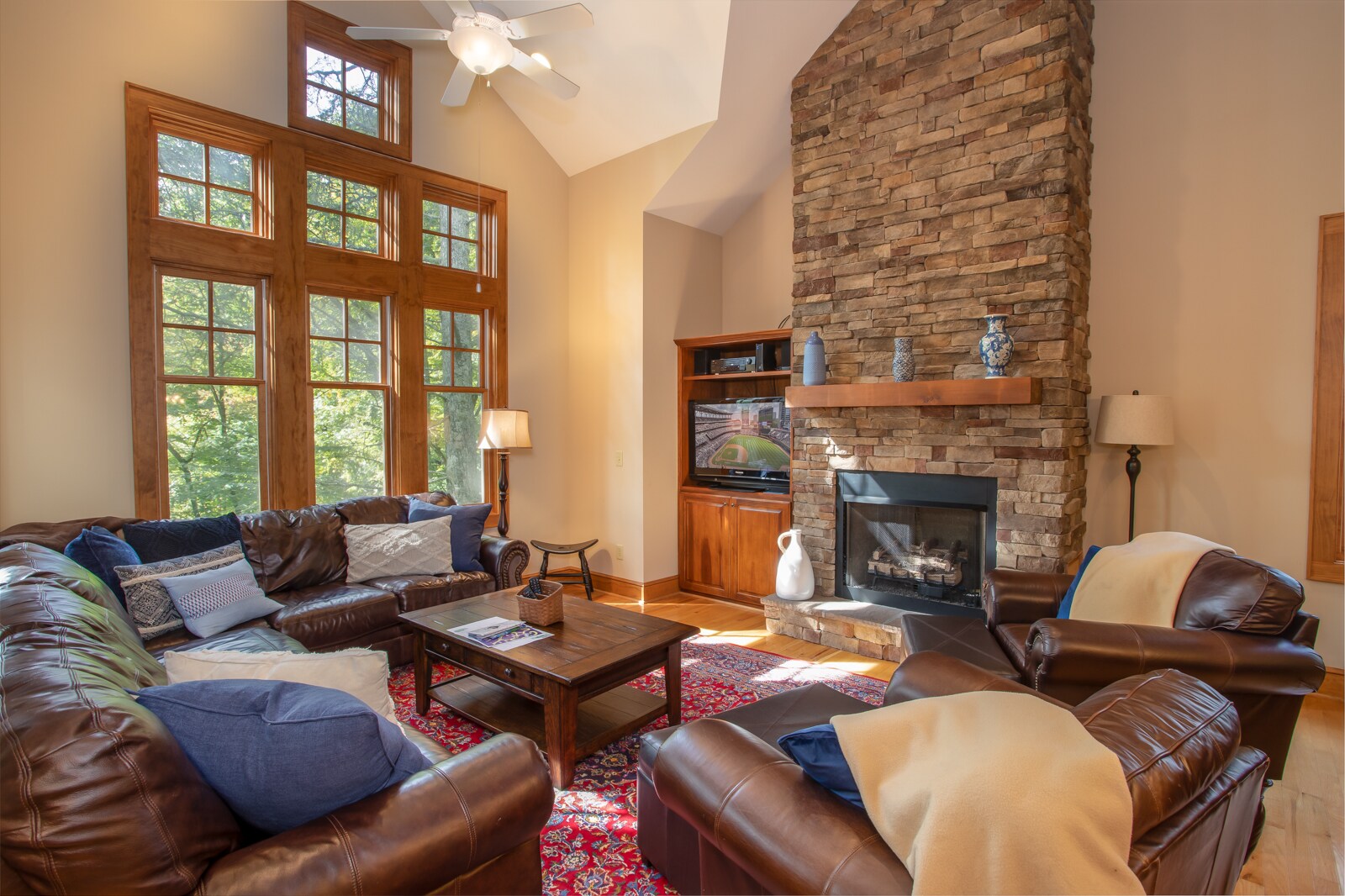 Great Room with Floor to Ceiling Stone Fireplace and Smart TV