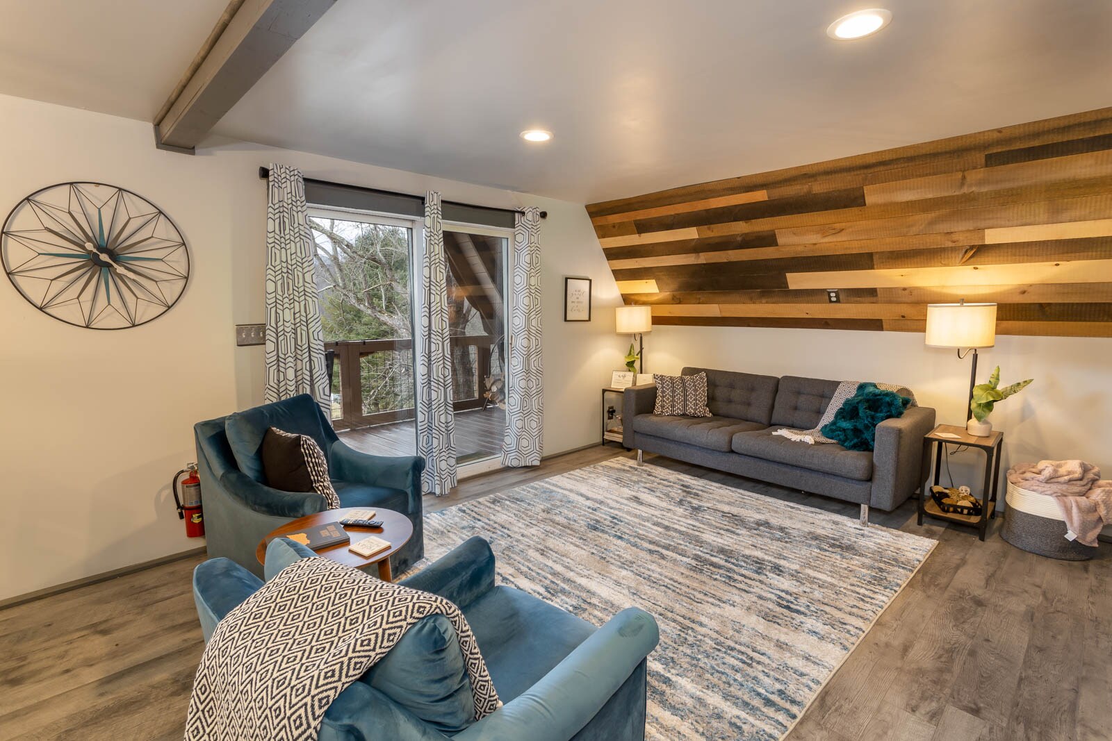 Main Level Living Room with Glass Door open to Covered Front Porch which frames Mountain Views