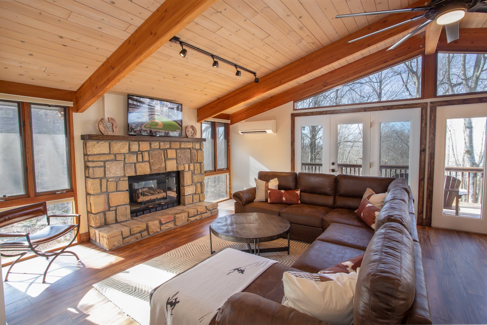 Living Room with Stone Fireplace, HD Smart TV, Comfy Leather Furniture