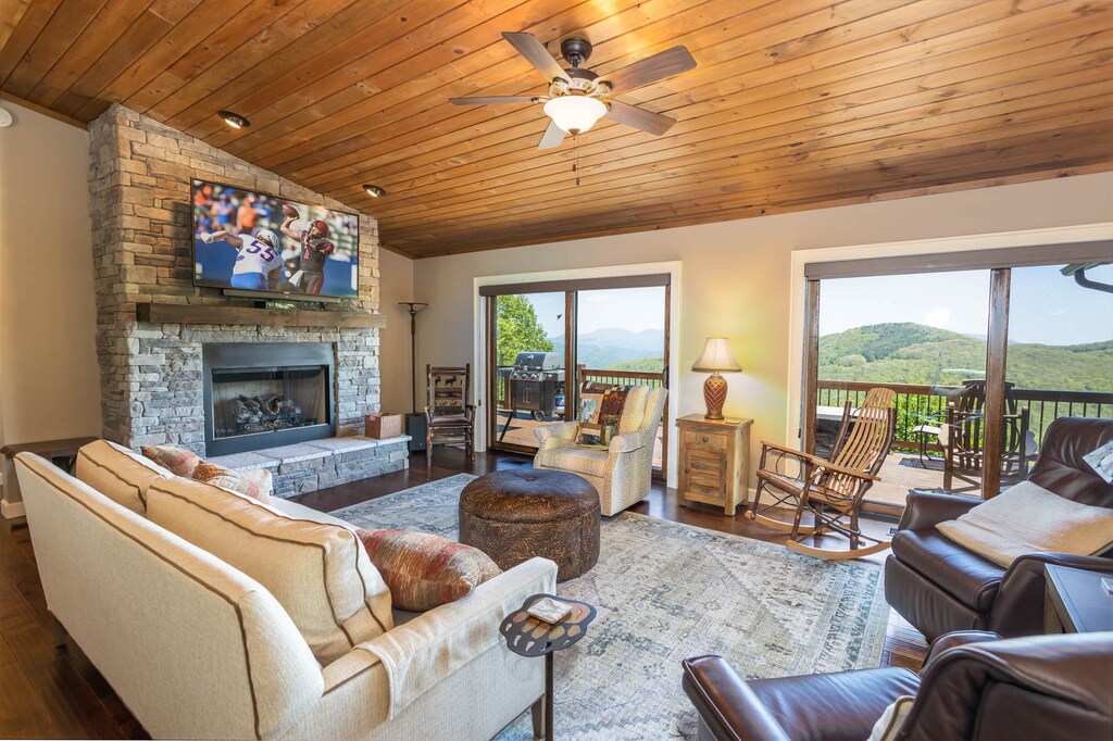 Living Room on the Top Floor has Stone Gas Fireplace and Mounted Flat Screen TV