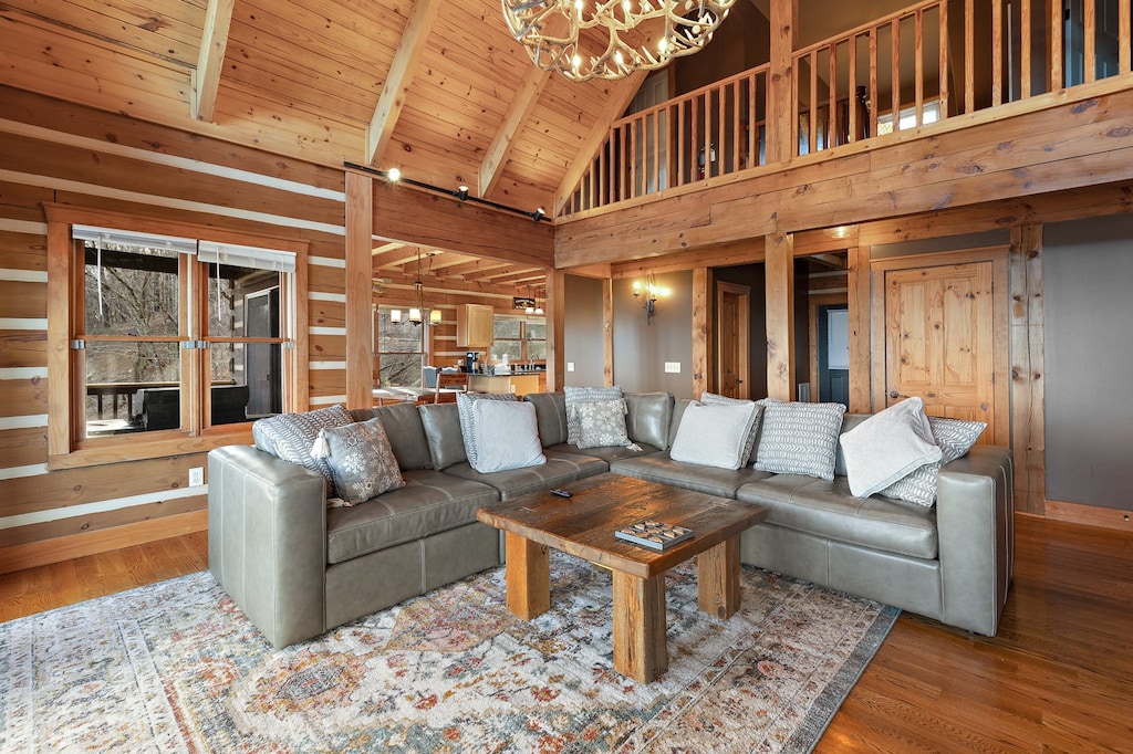 Great Room Leather Sectional with Antler Chandelier, Loft Above, and Dining Area Behind