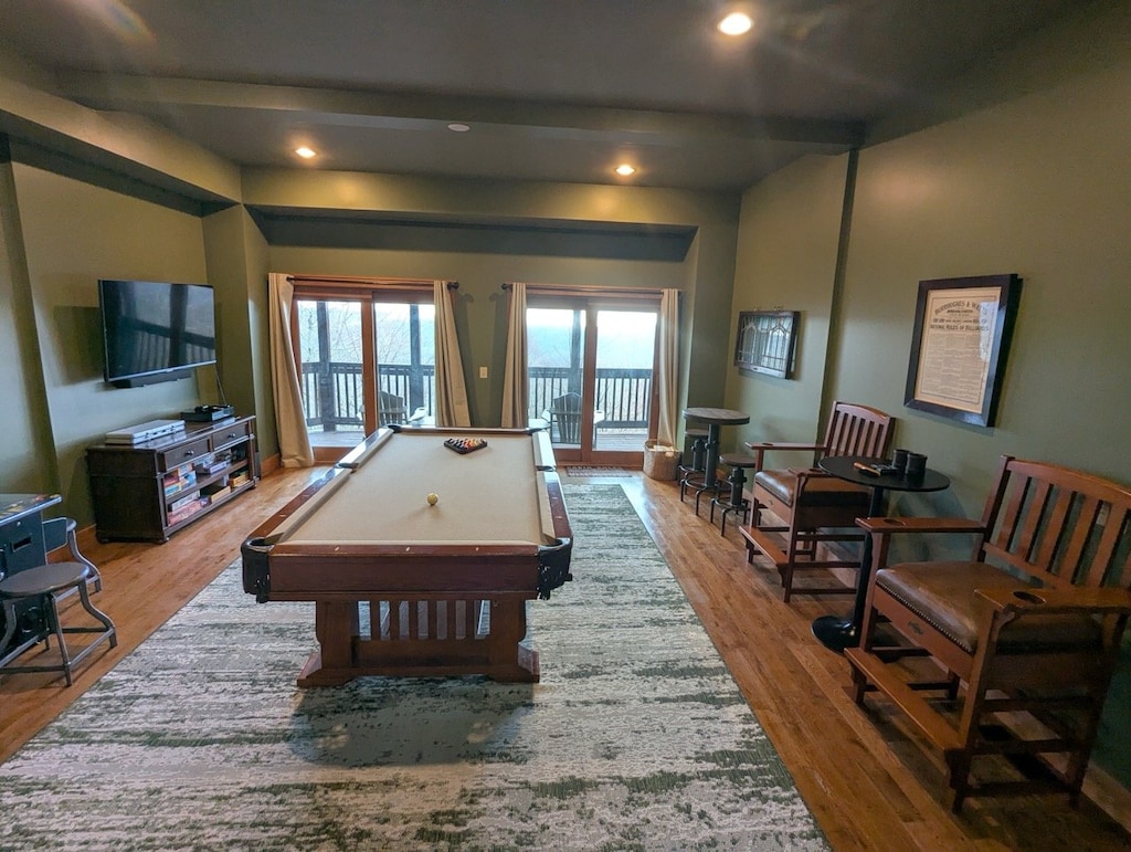 Lower Level Family Room has a Pool Table and Arcade Game with Lower Level Deck