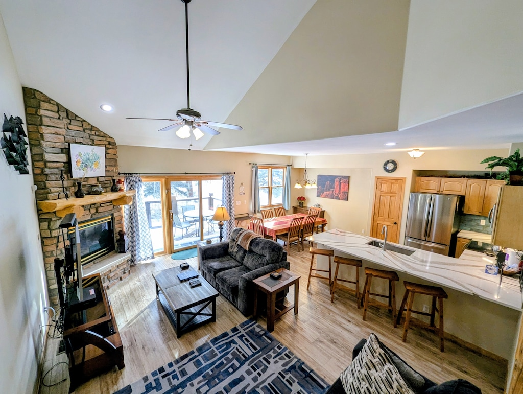 Relax in your open-concept retreat with stone fireplace, full kitchen, and cozy dining space perfect for mountain getaways.
