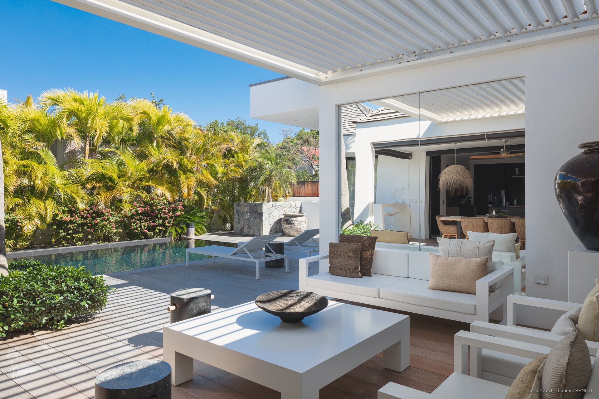 Lounge area on the covered part of the terrace next to the pool. 