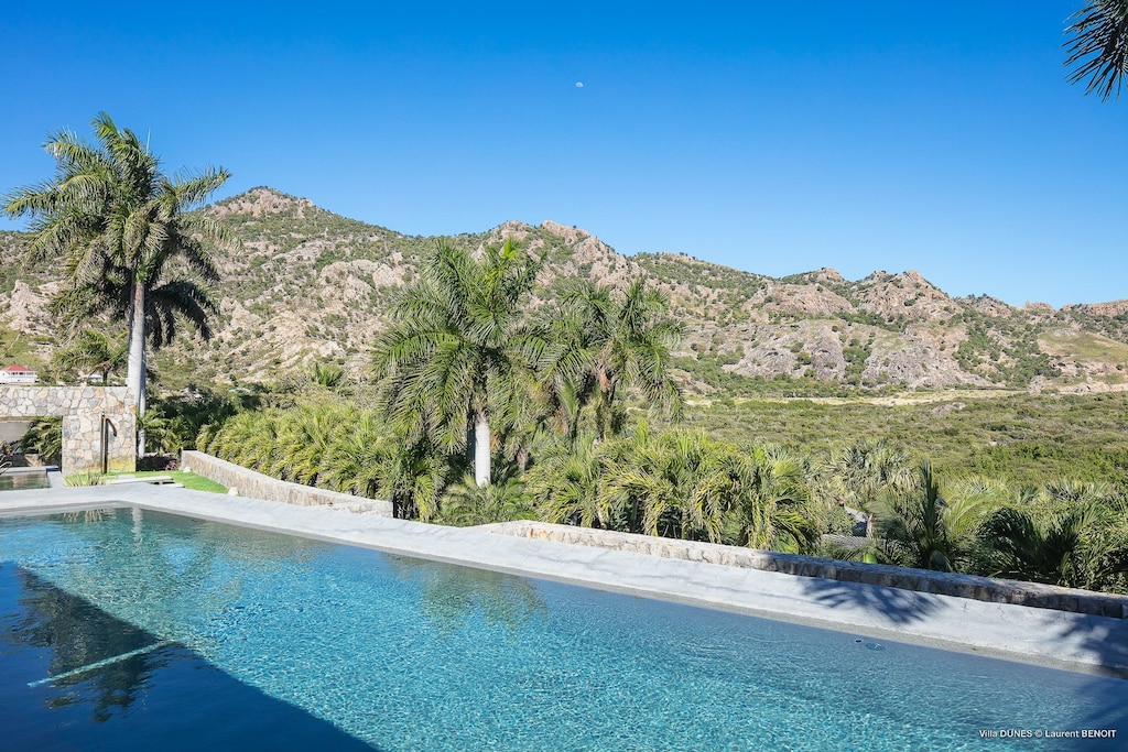 Two heated pools 3 x 18 m and 4 x 8 m, expansive terrace with lounge chairs.