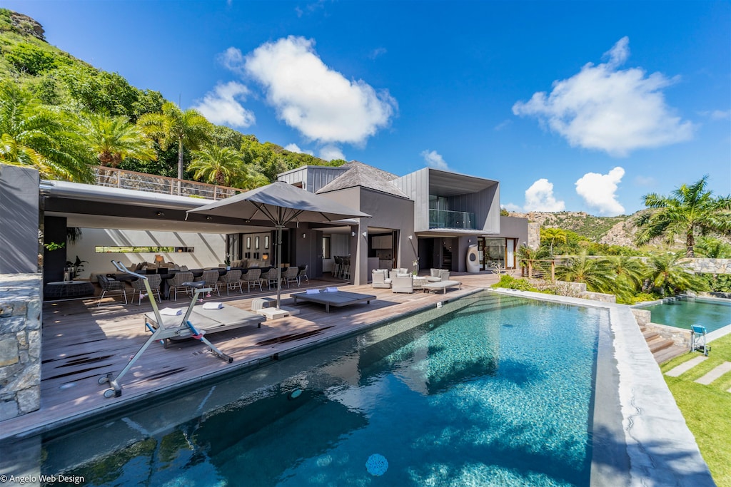 Two heated pools 3 x 18 m and 4 x 8 m, expansive terrace with lounge chairs.