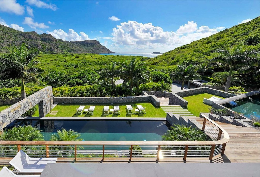 Two heated pools 3 x 18 m and 4 x 8 m, expansive terrace with lounge chairs.