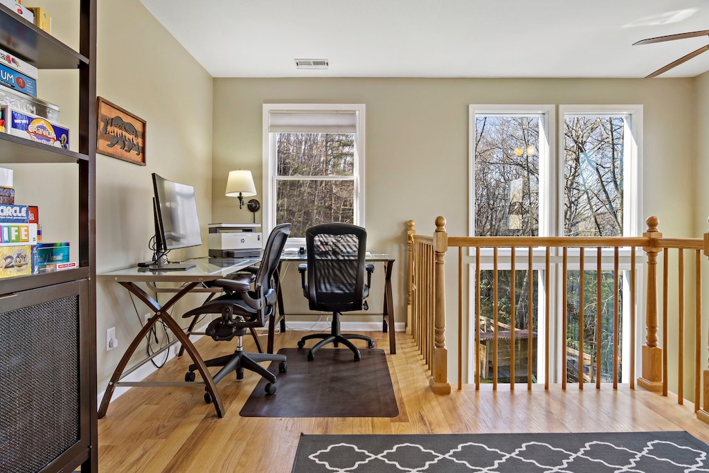 Impressive dedicated work area in the upstairs loft equipped with a fully-stocked desk, Herman Miller Aeron ergonomic chair, and printer.