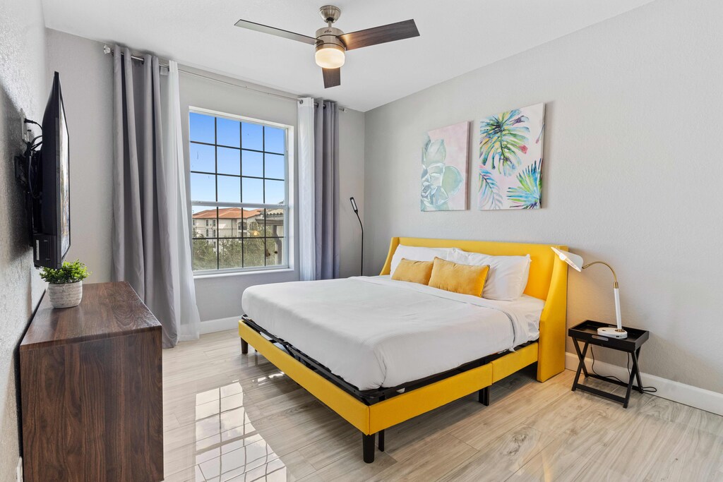 Chic bedroom of the condo in Orlando Florida - Cozy double bed with plenty of natural light, creating a bright and airy ambiance. - A perfect blend of contemporary design - Plush bedding, and an ambiance that exudes exclusivity