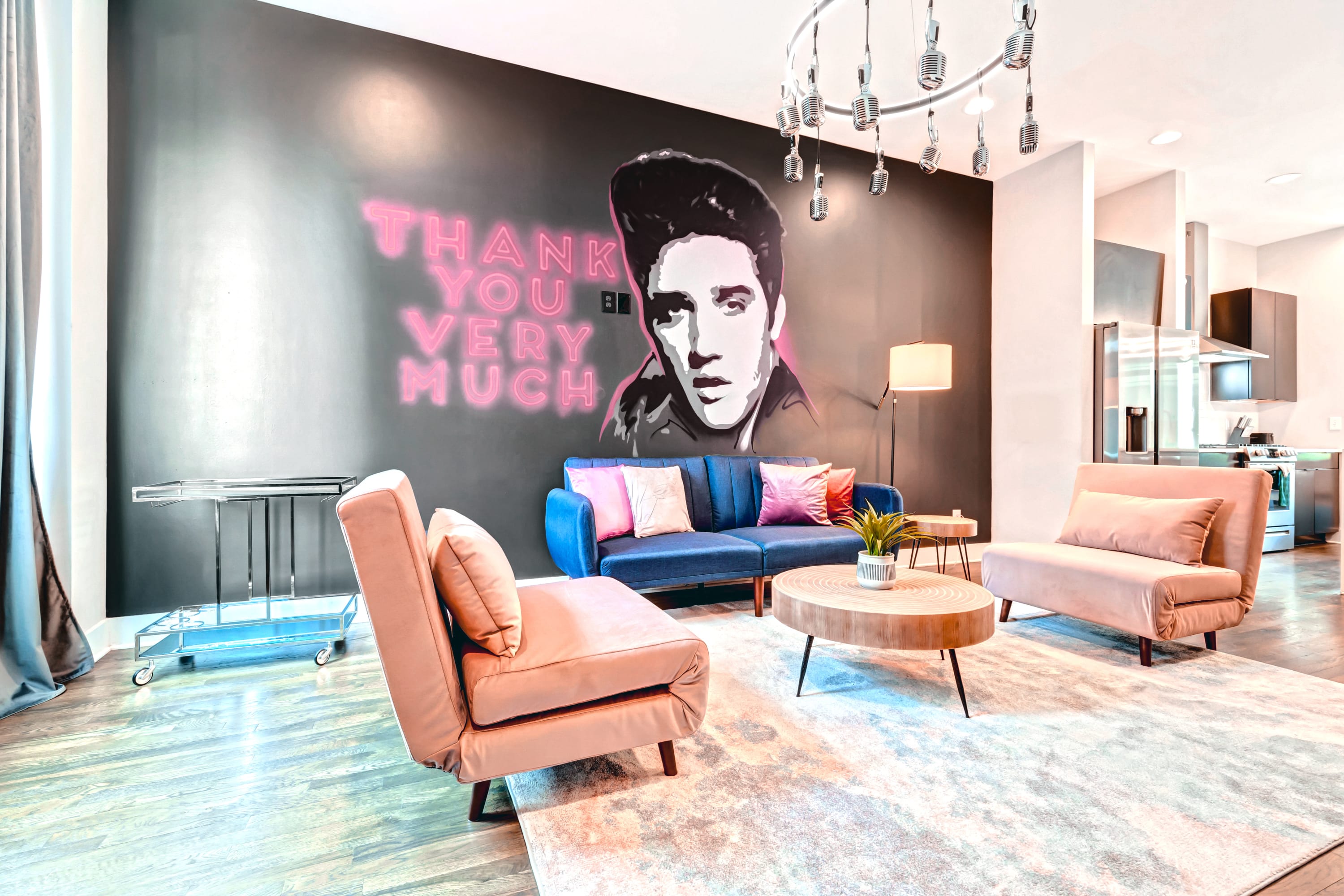 Gather your friends for a luxury getaway in this vibrant Nashville vacation rental, ideal for a Bachelorette bash or any group vacation. Lounge on the chic peach sofas under the gaze of the iconic Elvis mural. With its bright colors and pop culture flair, this space is ready to amp up your Music City experience. 

Book your stay with Misfit Homes now and dive into your Nashville adventure!