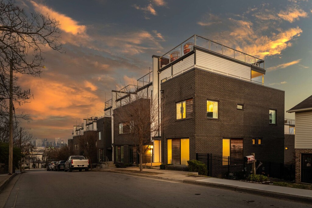 This street corner in Tennessee captures the glow of modern townhouses alive with guests inside, all set for a group getaway